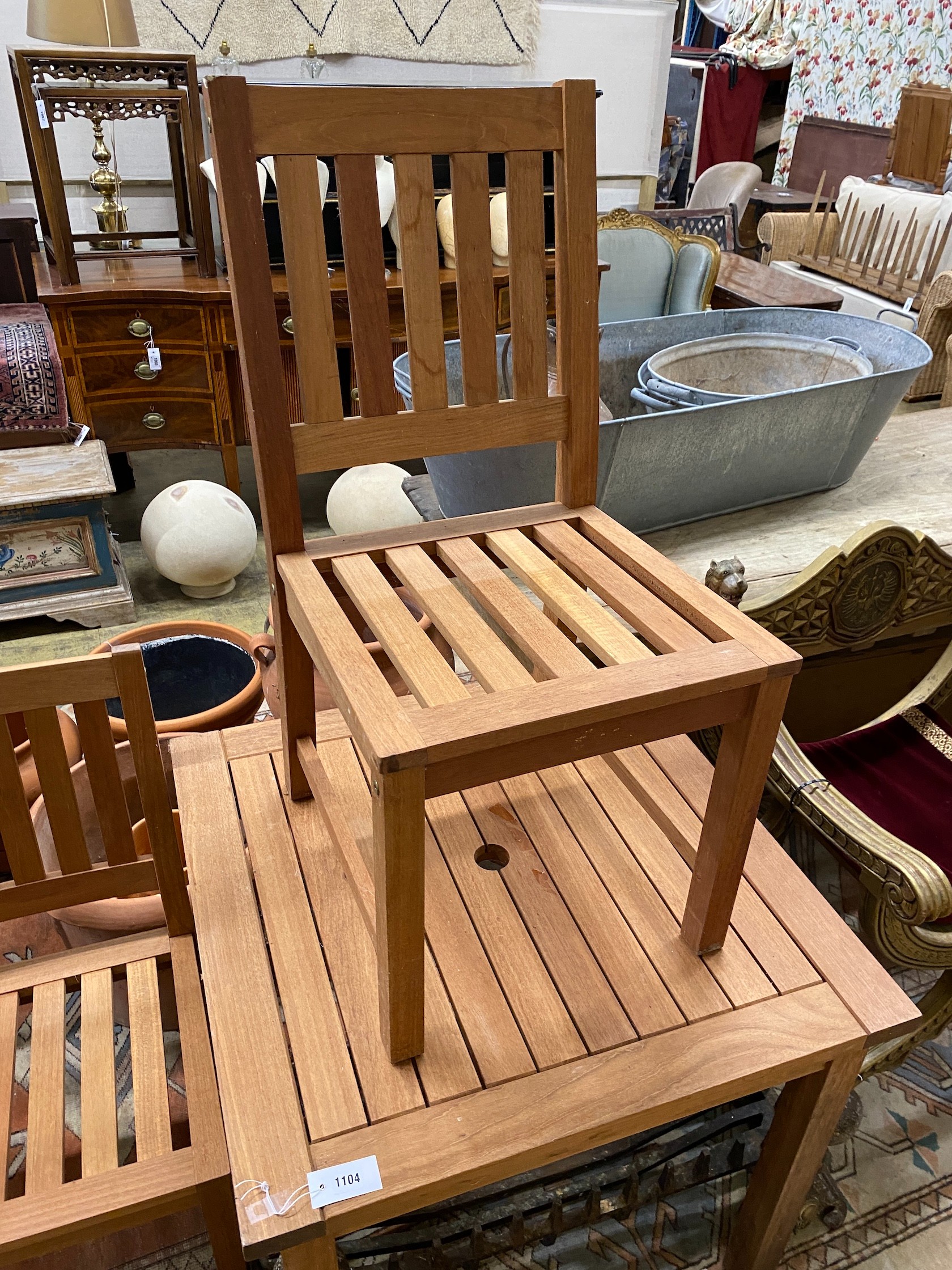 A square teak garden table, width 80cm, height 73cm together with two teak garden chairs